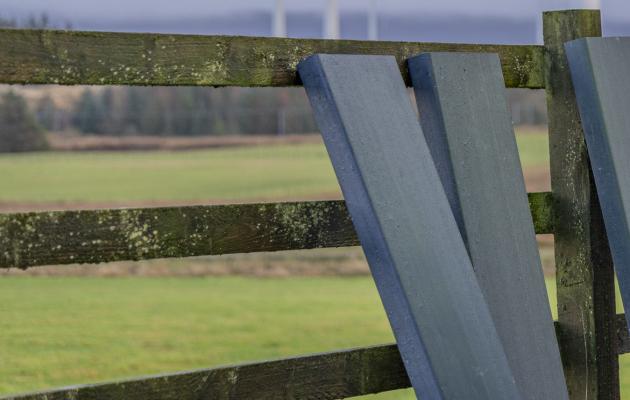 Bladeboards leaning against a fence