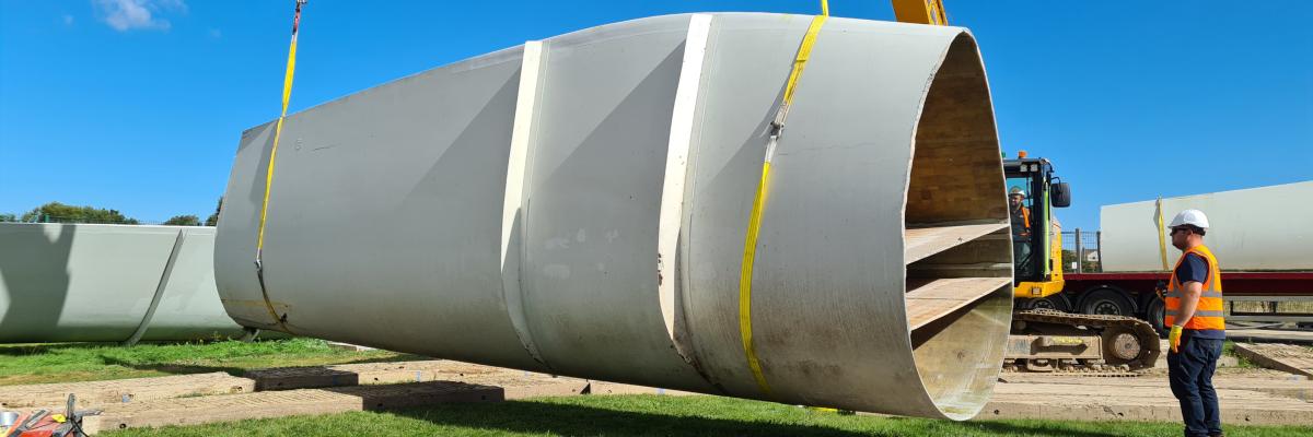 Decommissioned wind turbine blade segment being loaded